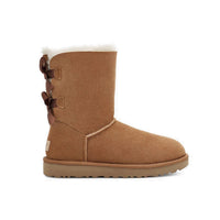 Ugg boot with two bows on the back and sheepskin lining inside. Color is chestnut.